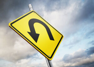 "Yellow U-turn road sign symbolizing a change in digital marketing strategy and business direction."